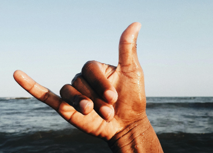 Shaka sign thumb and pinky fingers up in the ocean
